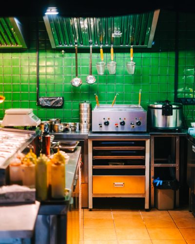 Kitchen table with professional equipment in a public cafe.